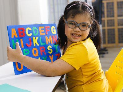 young girl reading the alphabet